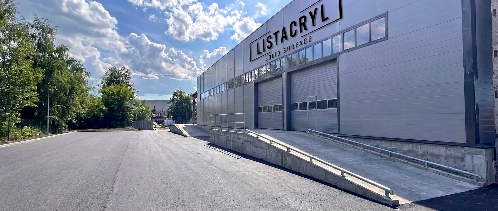 Фасад производственного корпуса LISTACRYL в Киришах с вывеской на стене здания